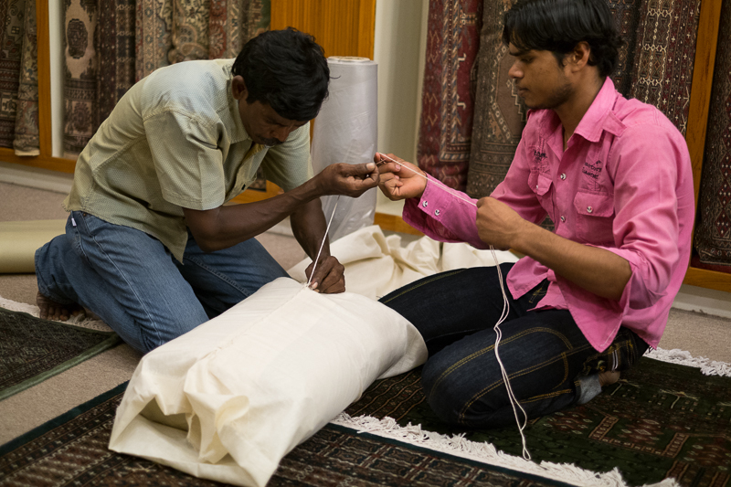 Men preparing my rug for transporting home, Museum Shop, Chennai