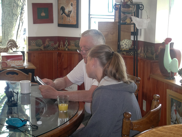 Bob Crites explaining the many exciting features of the Kindle to Brittany Baehr, Torch Lake