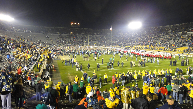 Party in Notre Dame Stadium: Students pour onto field after victory on Senior Day.