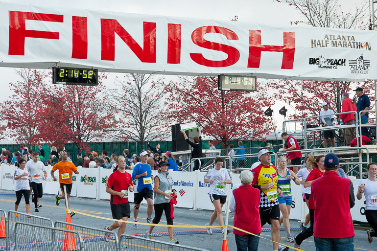 Kris Crites crossing the finish line at the Atlanta Half Marathon.